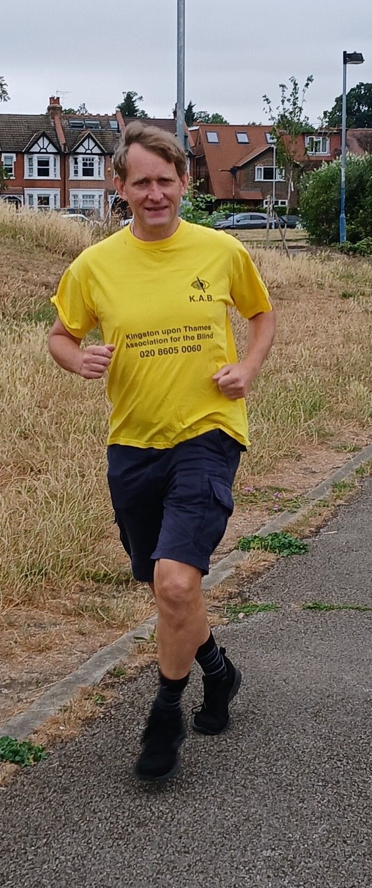 Image: Ashley wearing a KAB T-Shirt running in a park
